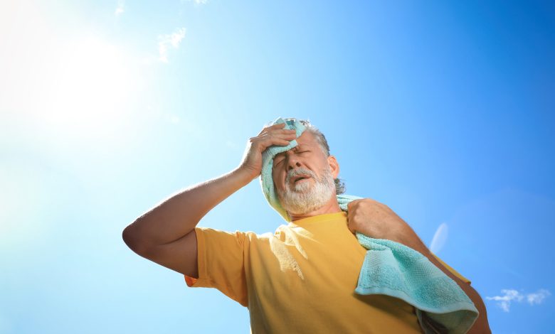 man wiping brow – Protecting Seniors from Heat-Related Risks – World Tech Power